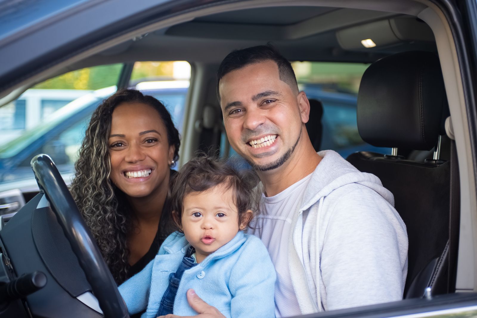 A family with the keys to their newly financed vehicle