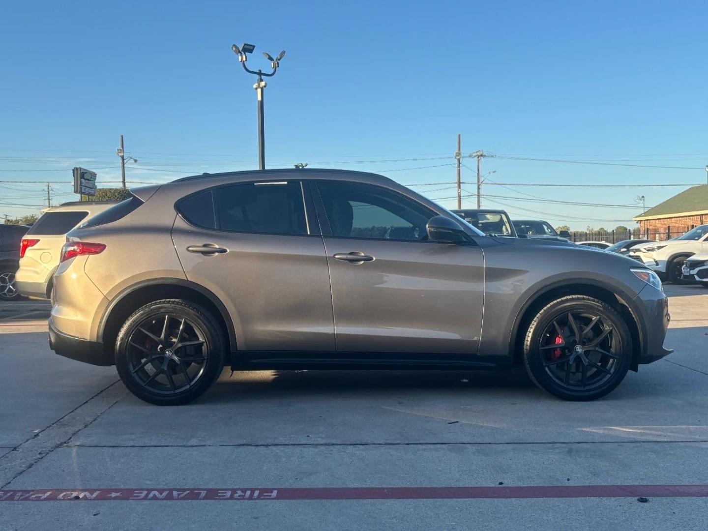 2019 Gray Alfa Romeo Stelvio Ti AWD (ZASPAKBN3K7) with an 2L I-4 gasoline direct injection engine, located at 2401 E Main St., Grand Prairie, TX, 75050, (972) 262-4440, 32.748981, -96.969643 - Photo#7